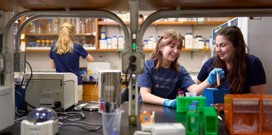 Two undergrad students working in a research lab