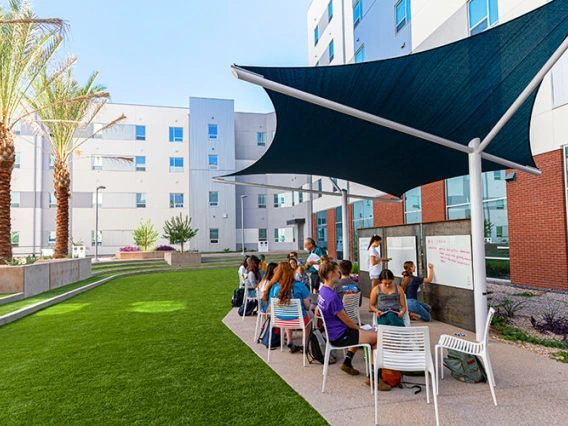 Courtyard of the Honors College with students taking a class outdoors