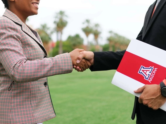 Two university of arizona professionals shaking hands