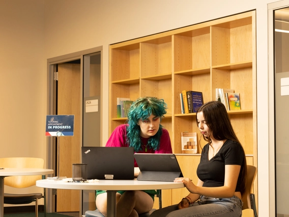 a student teacher helping another student