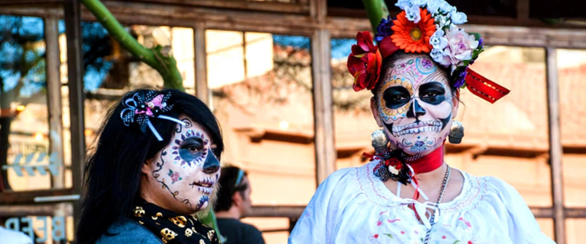 Students honoring Day of the Dead by painting their faces.