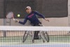 Den Baseda hitting a tennis abll in a wheelchair tennis match